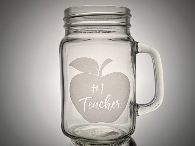 mason jar mug with an apple that says #1 teacher etch on the mug 