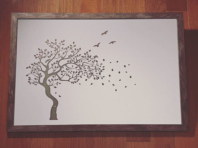 Mirror with a tree and birds etched on with a brown frame