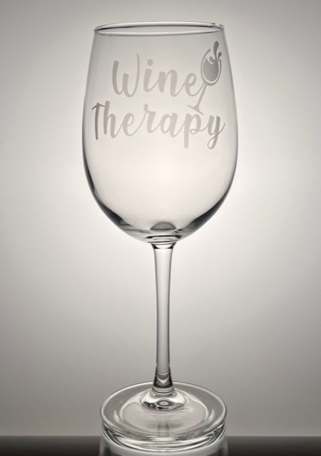 Wine glass that says "wine therapy" that is etched on the glass 