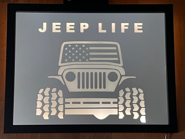 Custom mirror that have the saying "jeep life" and a picture of a jeep etched on a mirror with black frame