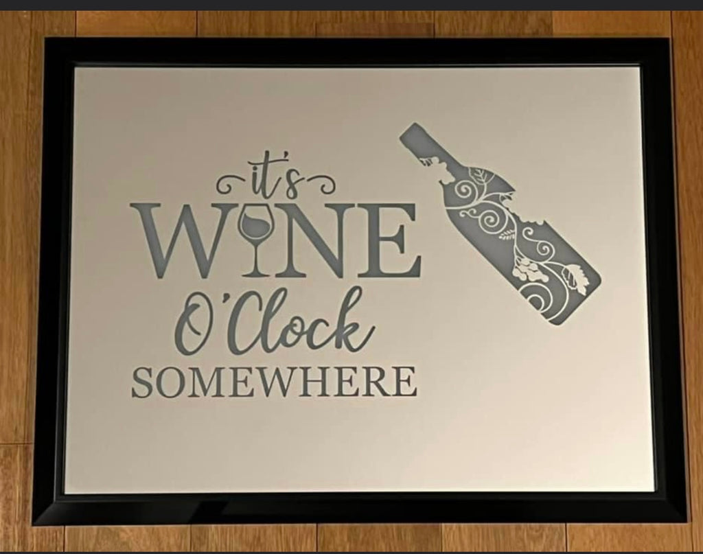 mirror that says "its wine O'clock somewhere" with a wine bottle etched on with a black frame