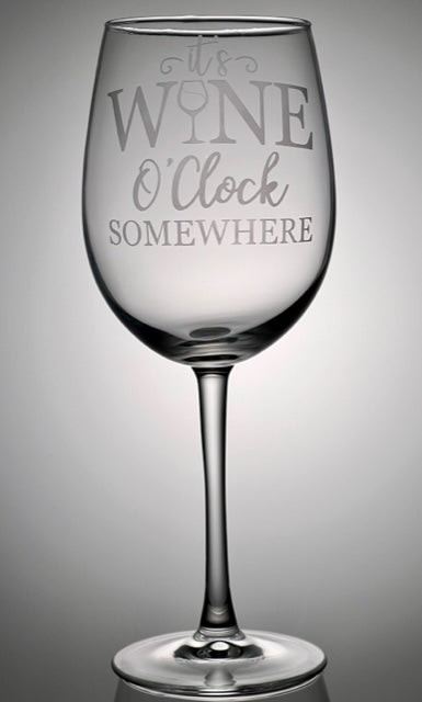 Wine glass that says "it's wine o'clock somewhere" that is etched on the glass 