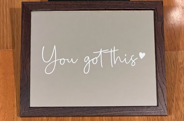 Mirror that say "you got this" with a heart etched on a mirror with brown frame 